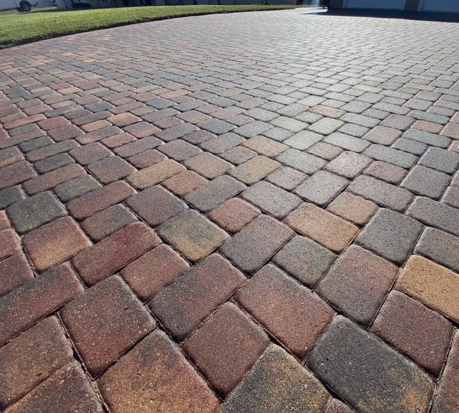Freshly pressure washed herringbone brick paver driveway