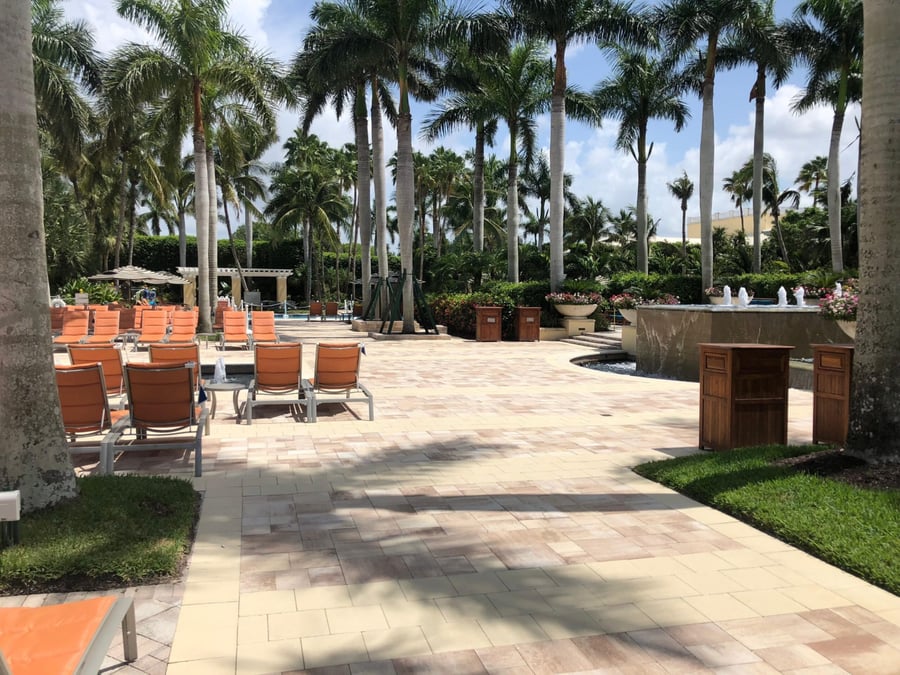 Resort promenade in blended pavers with fountains and royal palms