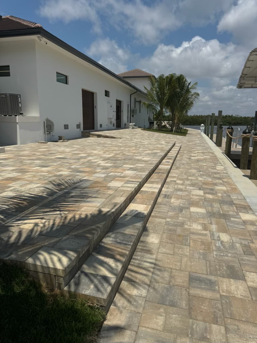 Large paver patio with wide step treads at a waterfront home