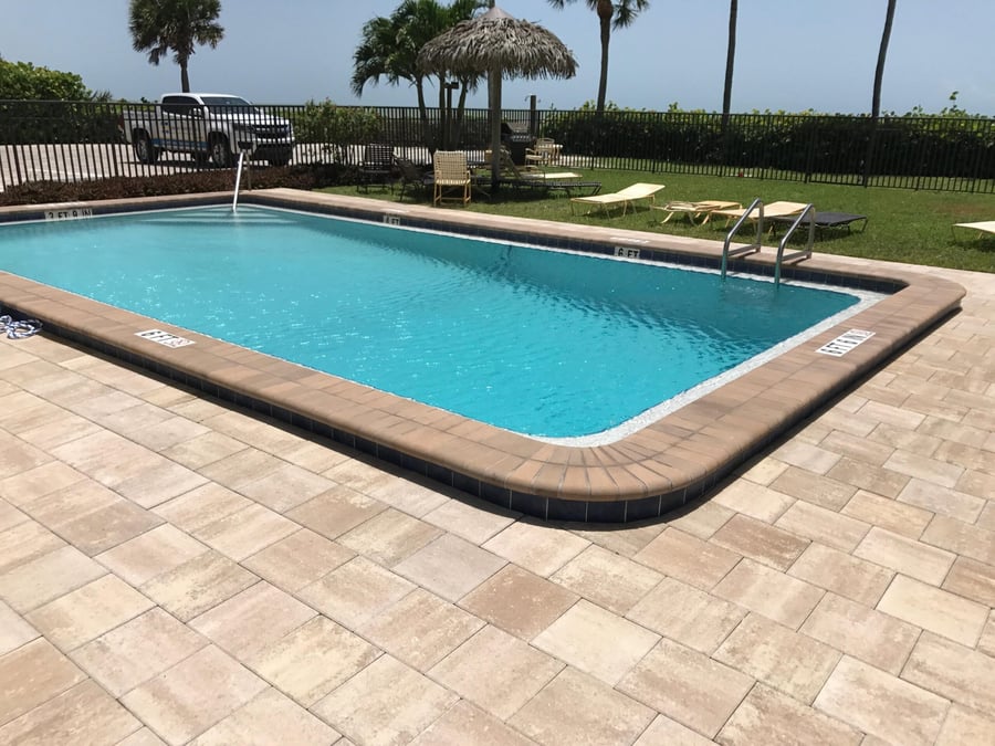 Gulf-front pool with paver deck and bullnose coping