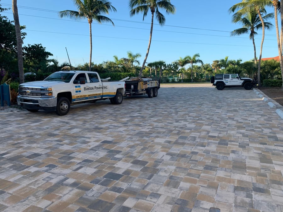 Club parking court in blended tan and gray pavers with Bastos truck and trailer