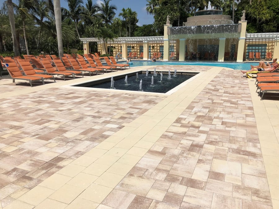 Resort pool deck with tiered fountain and paver courtyard