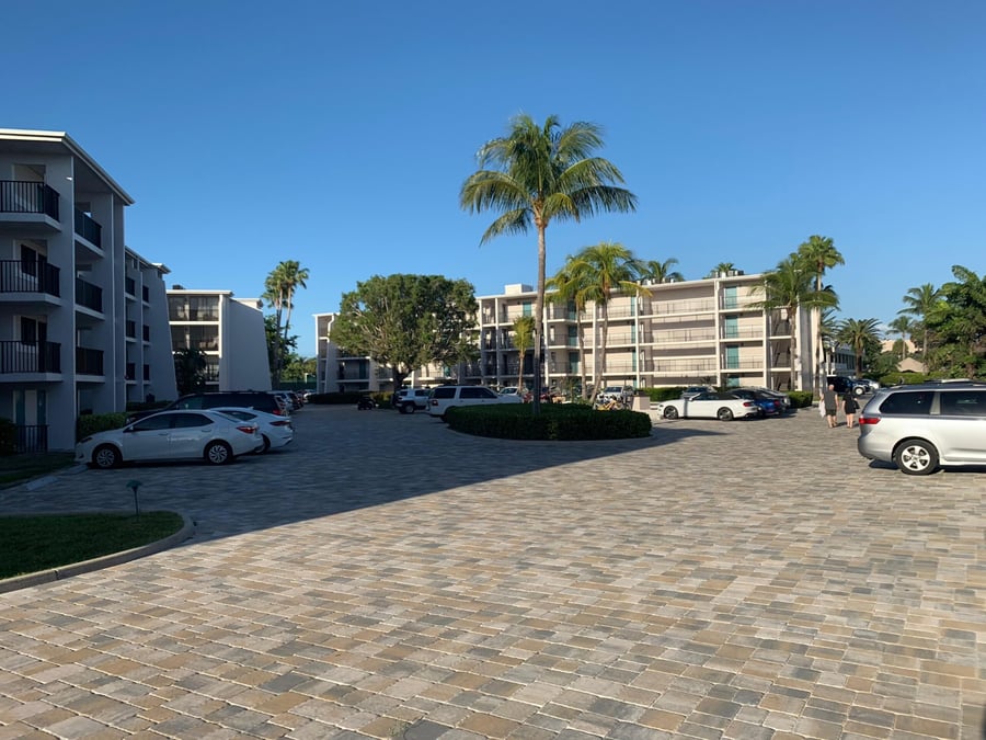 Large paver parking court between beachfront condominium buildings