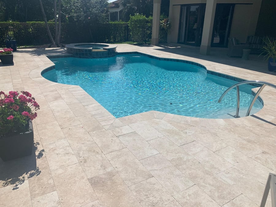 Ivory travertine pool deck with spa and freeform pool