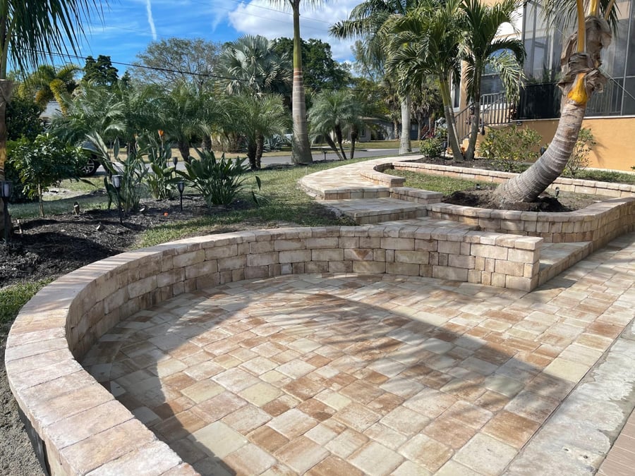 Travertine seat wall, entry patio and steps with palms