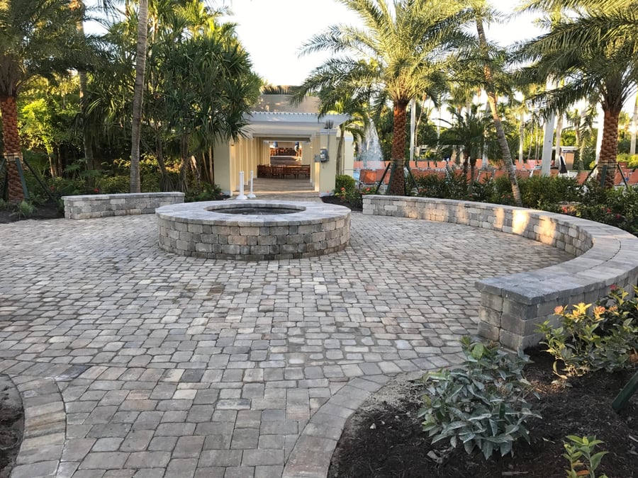 Resort cobble patio with circular fire pit and curved seat walls