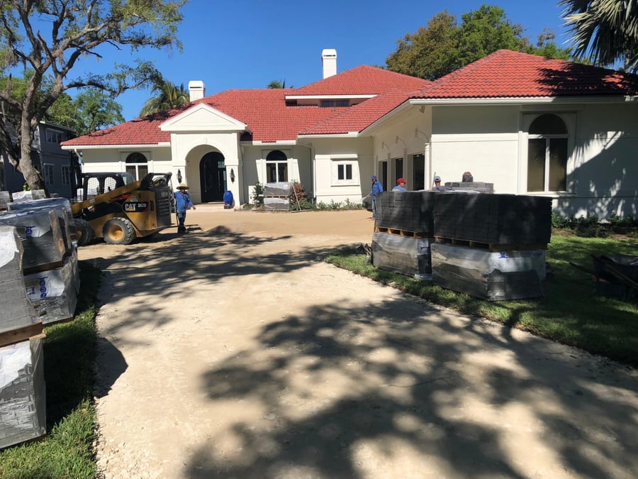 Bastos Pavers crew staging pallets for an estate driveway installation