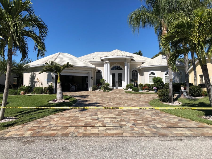 New paver driveway at a palm lined estate entrance