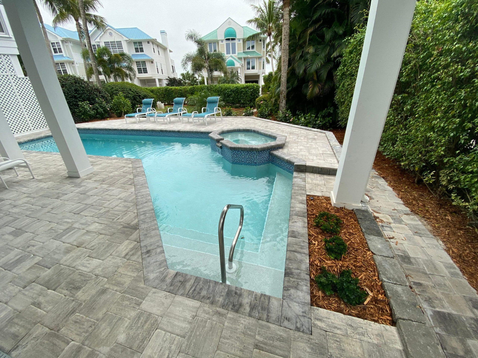 Gray paver pool and spa deck at an island residence