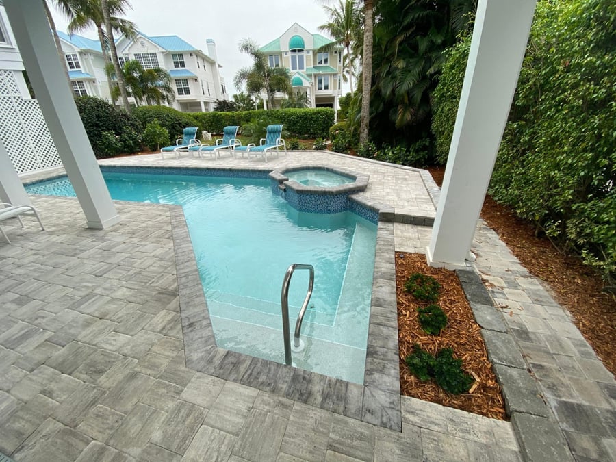Gray paver pool and spa deck at an island residence