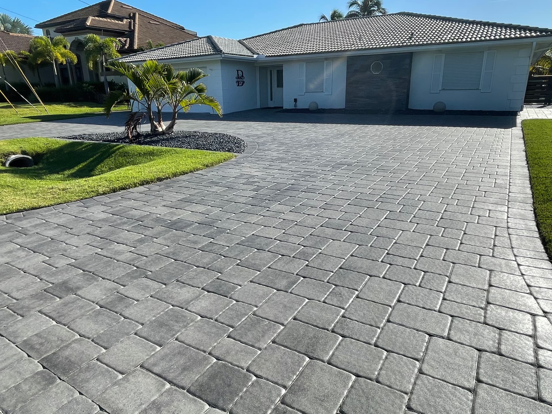 Cleaned and sealed gray paver driveway