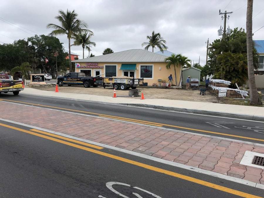 Brick paver crosswalk and sidewalk in front of a beach storefront