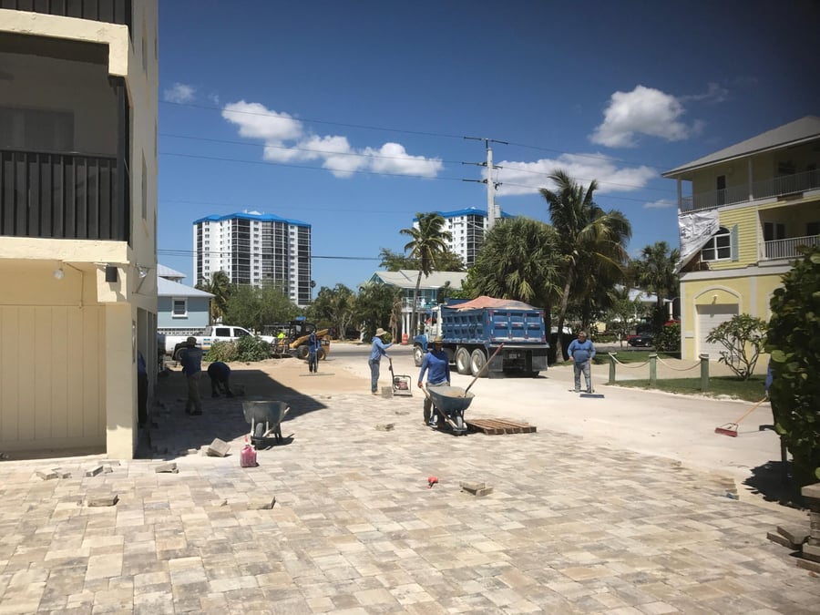 Crew installing pavers at a beachfront condo drive