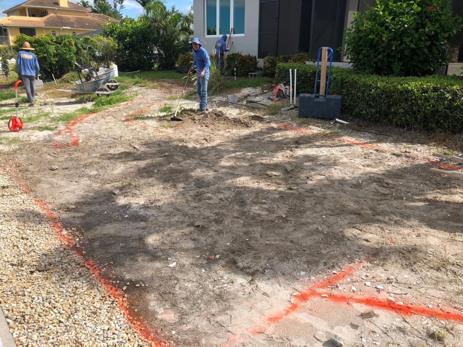 Bastos crew grading and marking the layout for a new paver driveway