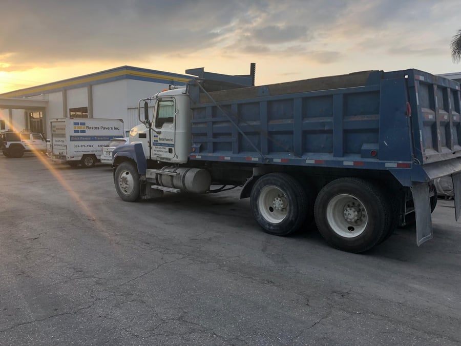 Bastos Pavers dump truck at the yard at sunset