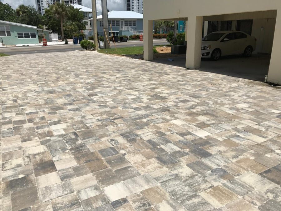 Blended paver driveway leading to a beach home carport