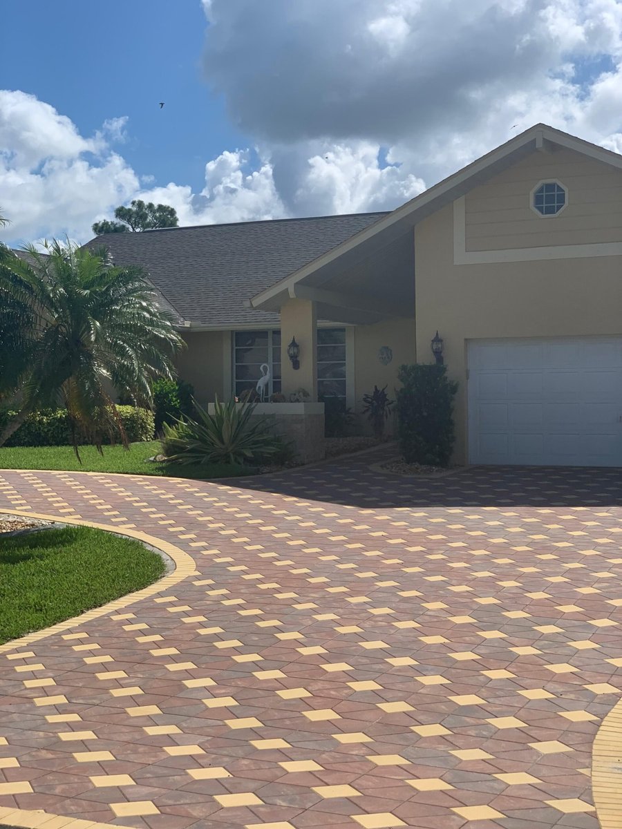 Decorative two tone paver driveway with circular pattern