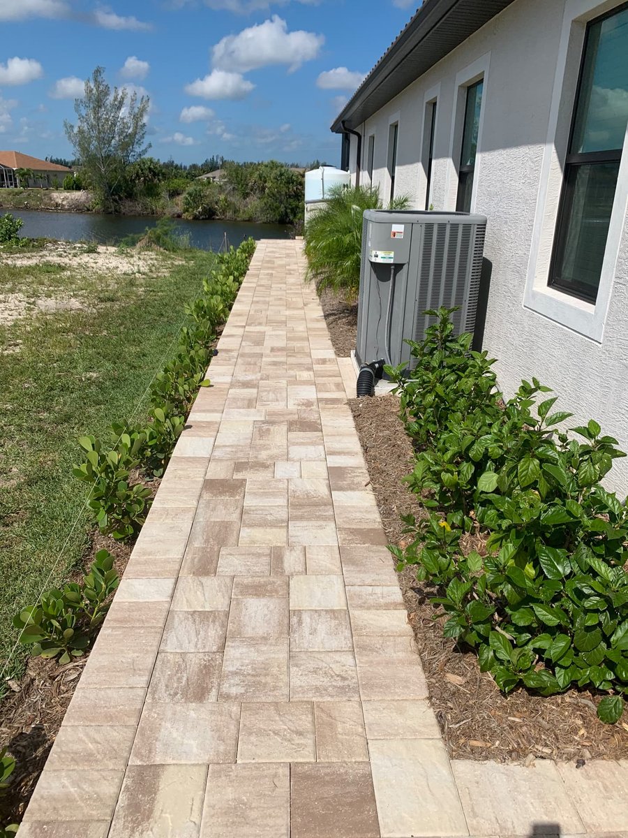 Side-yard paver walkway along a lakeside home