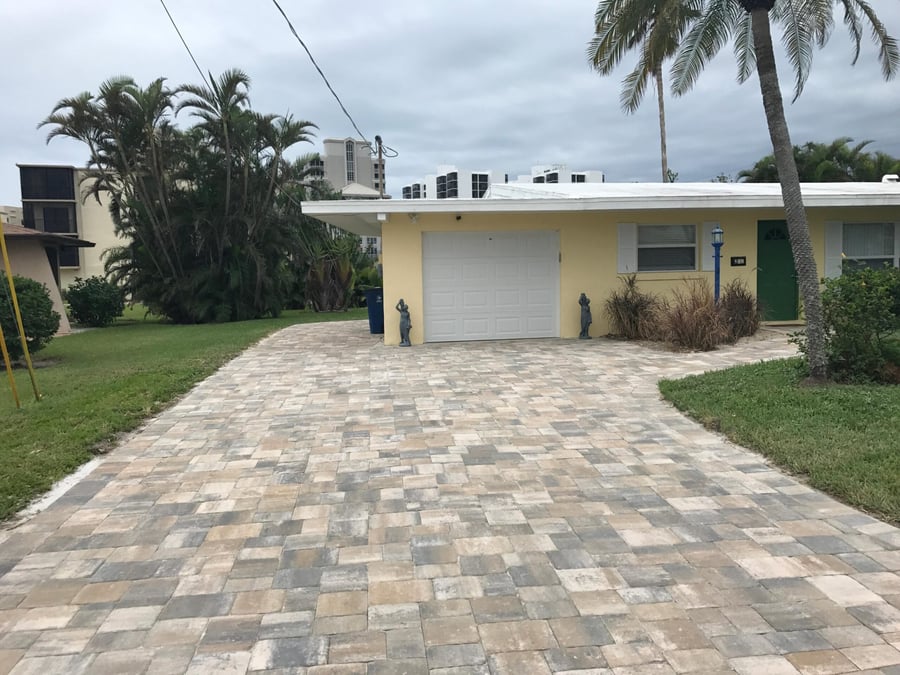 Wide tumbled paver driveway at a coastal cottage