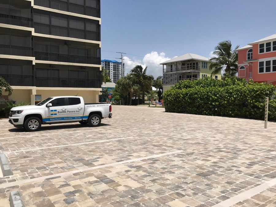 Beachfront condo parking court with striped paver stalls