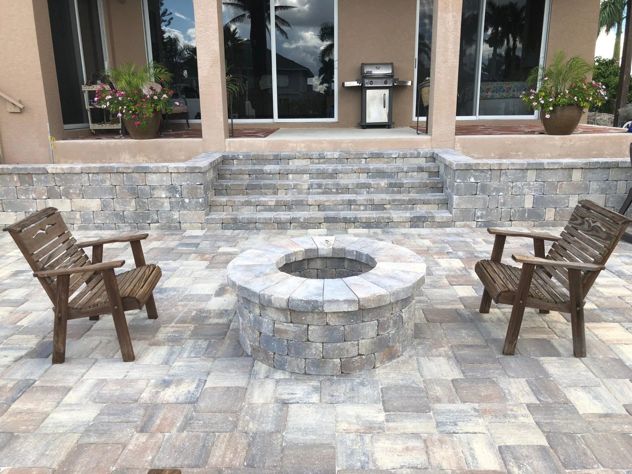 Paver patio with round fire pit, seat wall and steps