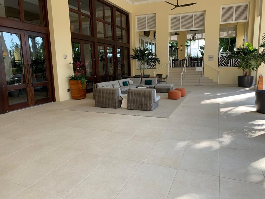 Clubhouse terrace in large-format ivory porcelain pavers with lounge seating