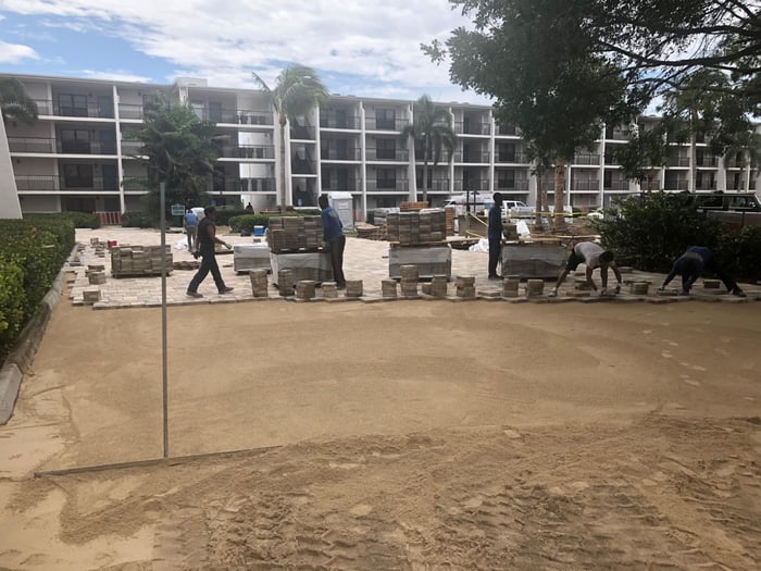 Crew installing pavers at a condominium courtyard