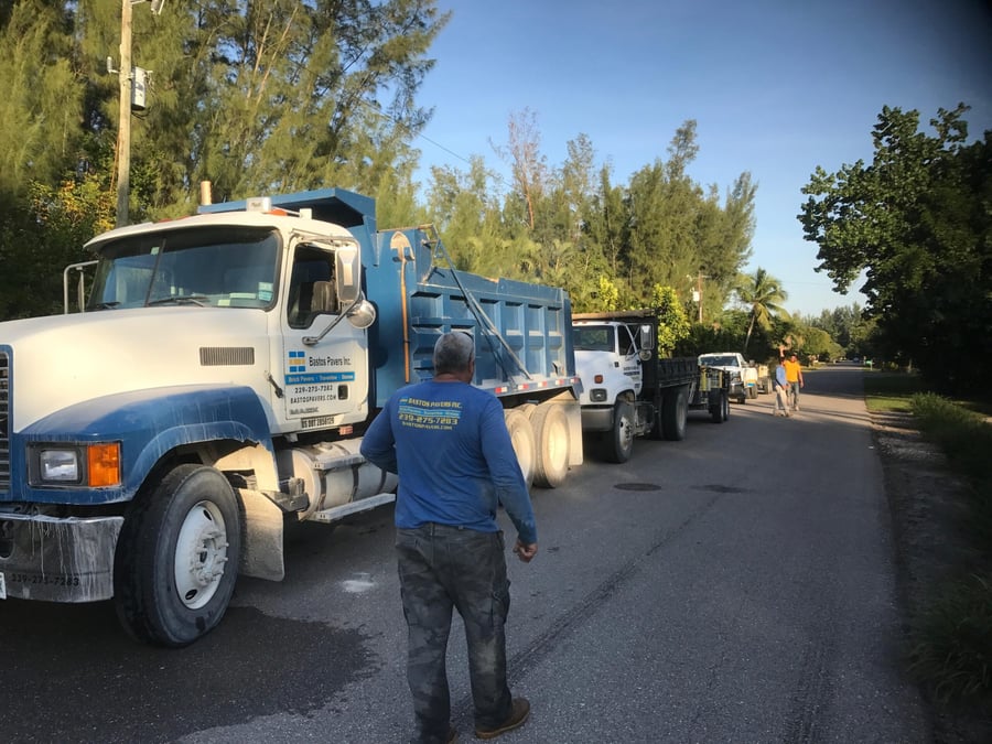Bastos dump trucks and trailers staged along an island street
