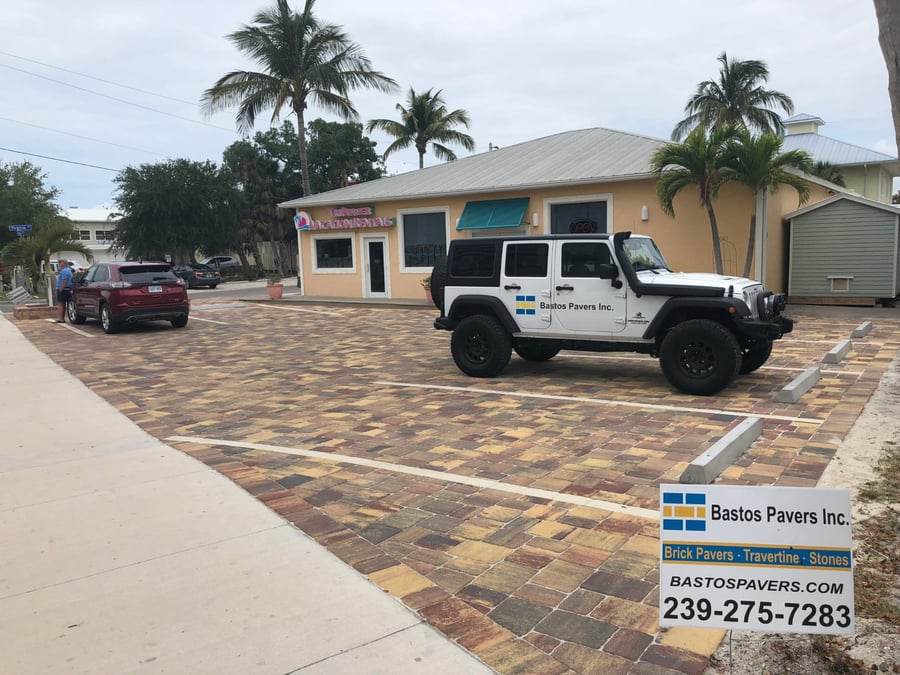 Beach rental office parking lot in multicolor brick pavers with Bastos Jeep