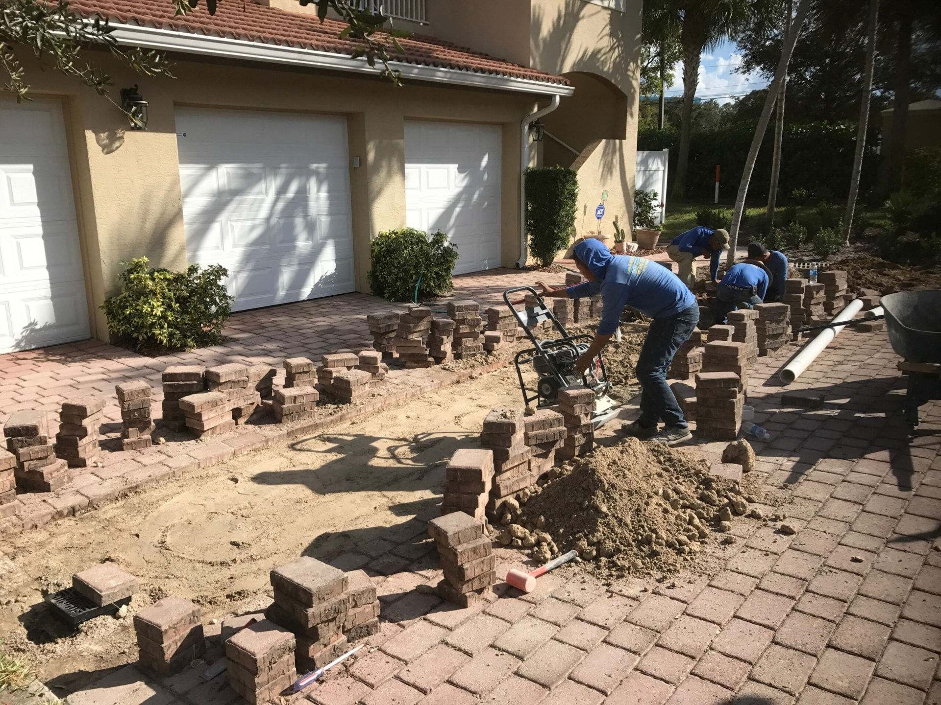 Bastos Pavers crew rebuilding a paver driveway in Fort Myers