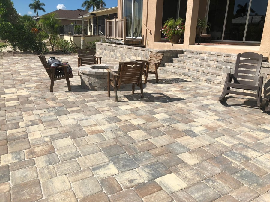 Backyard paver patio with fire pit and long seat wall