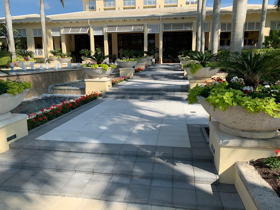 Wide paver entry steps and walkway at a resort entrance