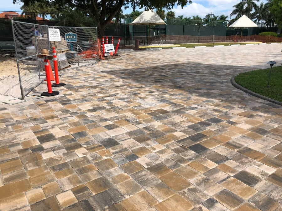 Blended paver plaza beside club tennis courts under construction
