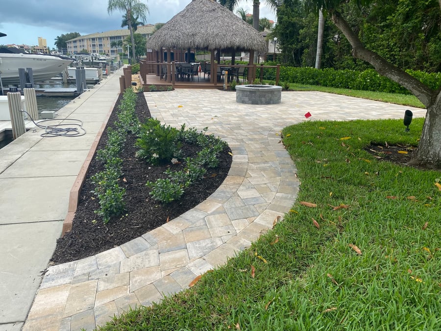 Marina-side paver walkway and patio with fire pit and tiki hut