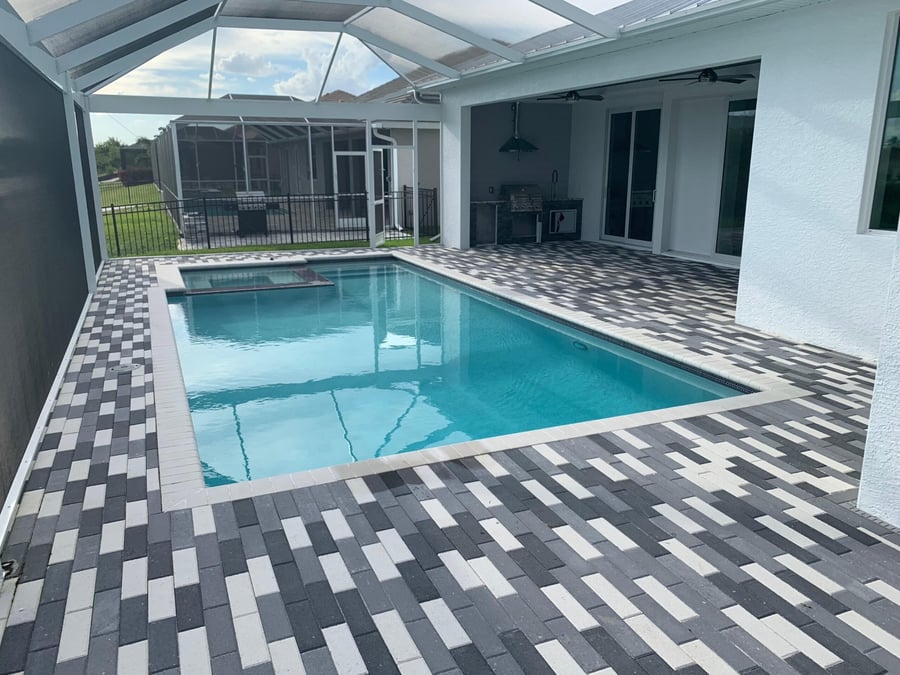 Charcoal and white checkered plank paver pool deck