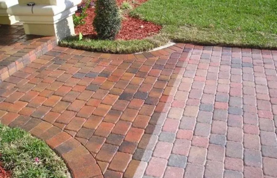 Half sealed brick paver driveway showing the restored color