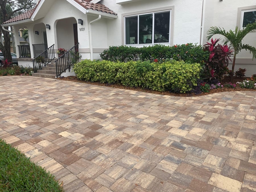 Blended paver driveway with fresh landscape beds at a front entry