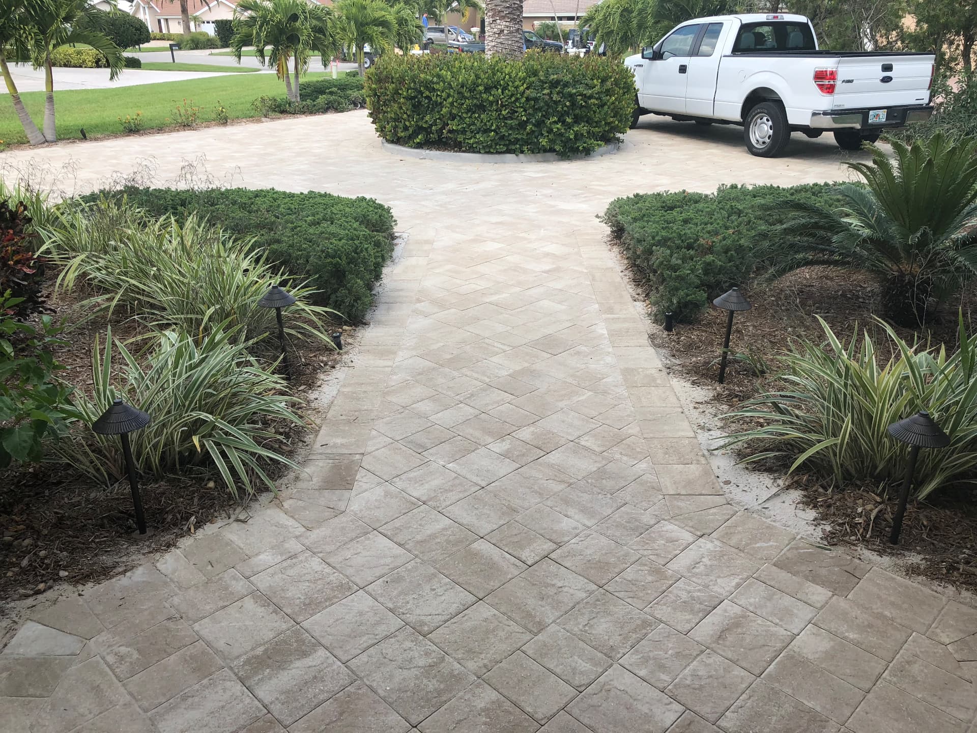 Herringbone paver walkway between planting beds