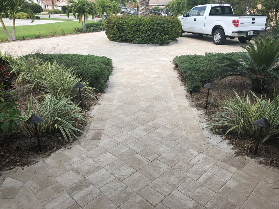 Herringbone paver walkway between planting beds