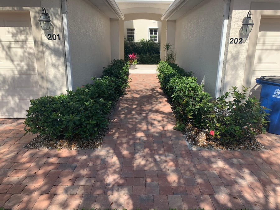 Brick paver entry walkway between two villa garages