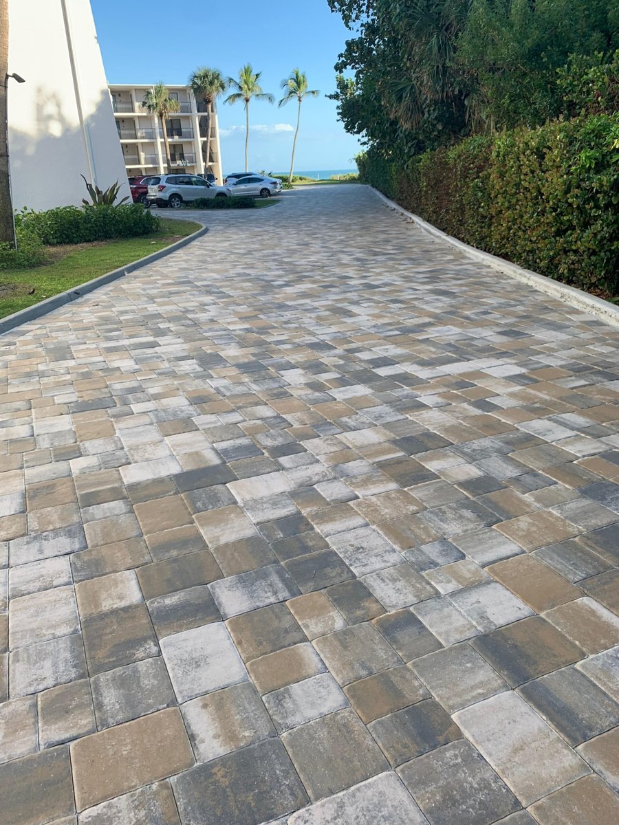 Condo entry drive in blended pavers with a Gulf view