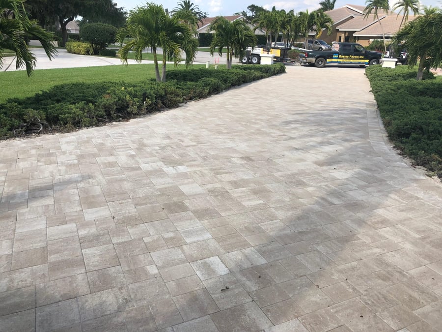 Silver plank paver driveway with Bastos Pavers trucks on site