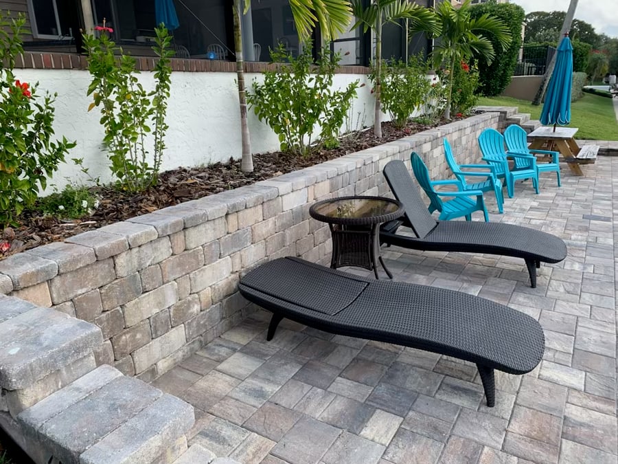 Segmental retaining wall with paver patio and lounge chairs