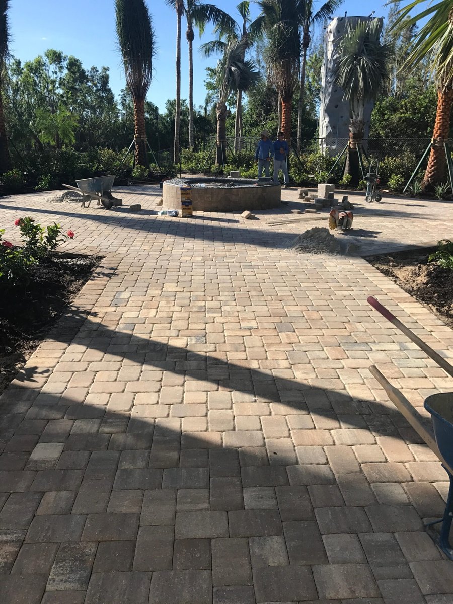Fire pit and cobble patio under construction at a resort amenity area