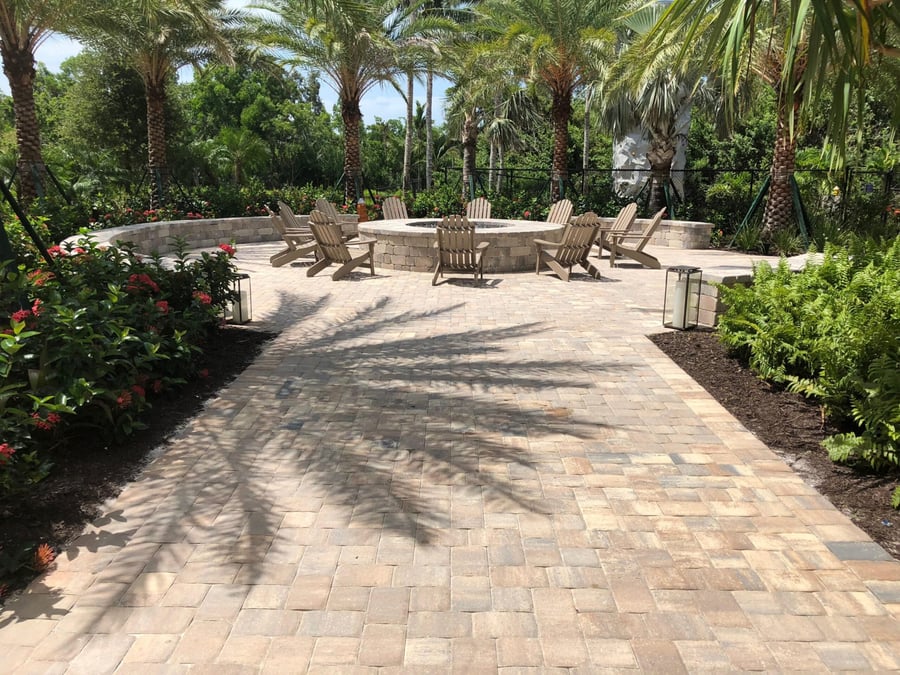 Resort fire pit lounge with curved seat wall and wide paver walkway
