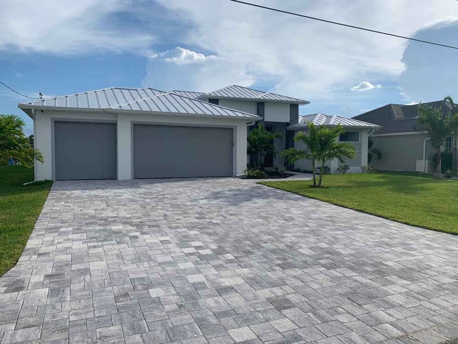 Silver travertine driveway at a modern coastal home